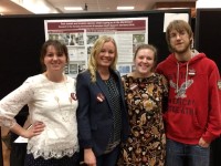 Four people (Sarah, Emily, Anabelle, Shane) standing in front of research poster