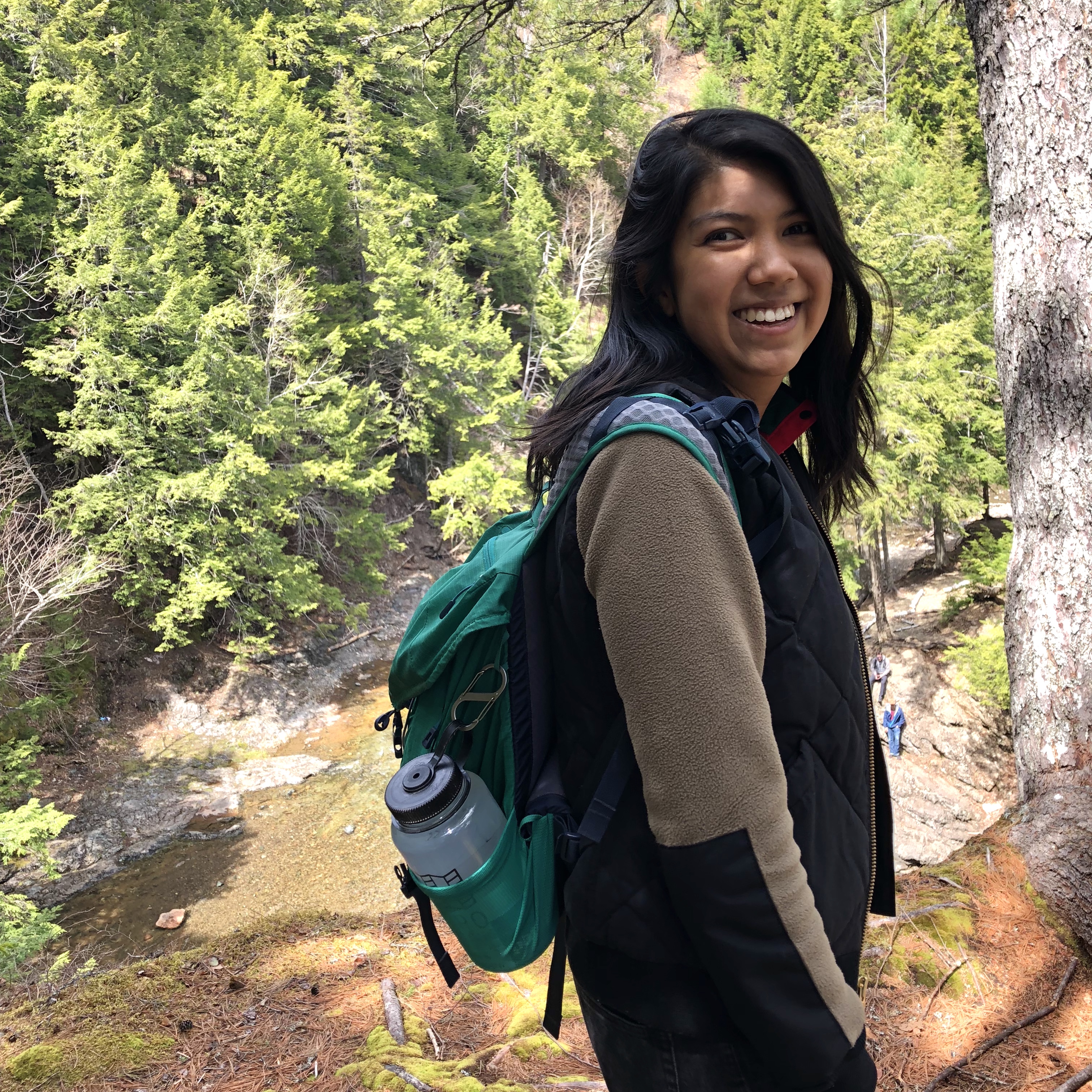 Megan Fong wearing a backpack in the forest