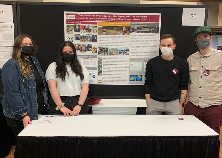 A group of four masked people standing by a research poster.  From L to R: Erin Francheville, Heidi Gavel, David Lewis (@DML_95) and Bradley Knockwood. 