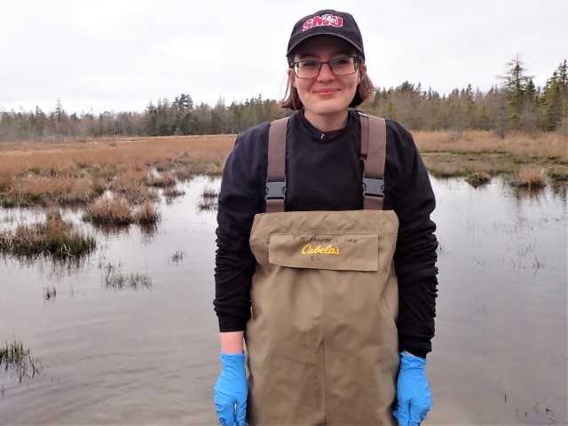 Meghan wearing waders at work