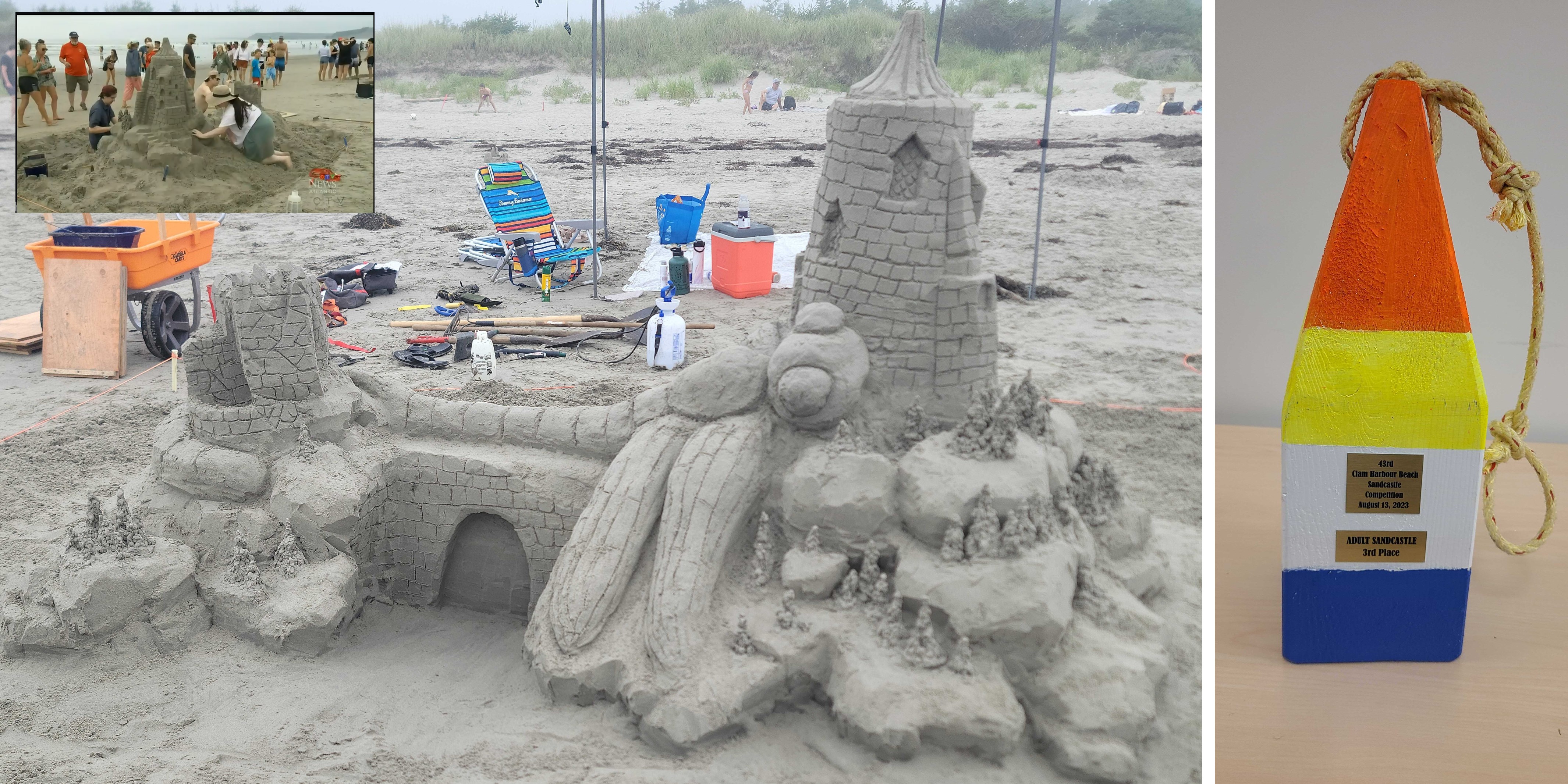Sand sculpture of a dragonfly attacking a castle, with the third-place buoy trophy next to it.